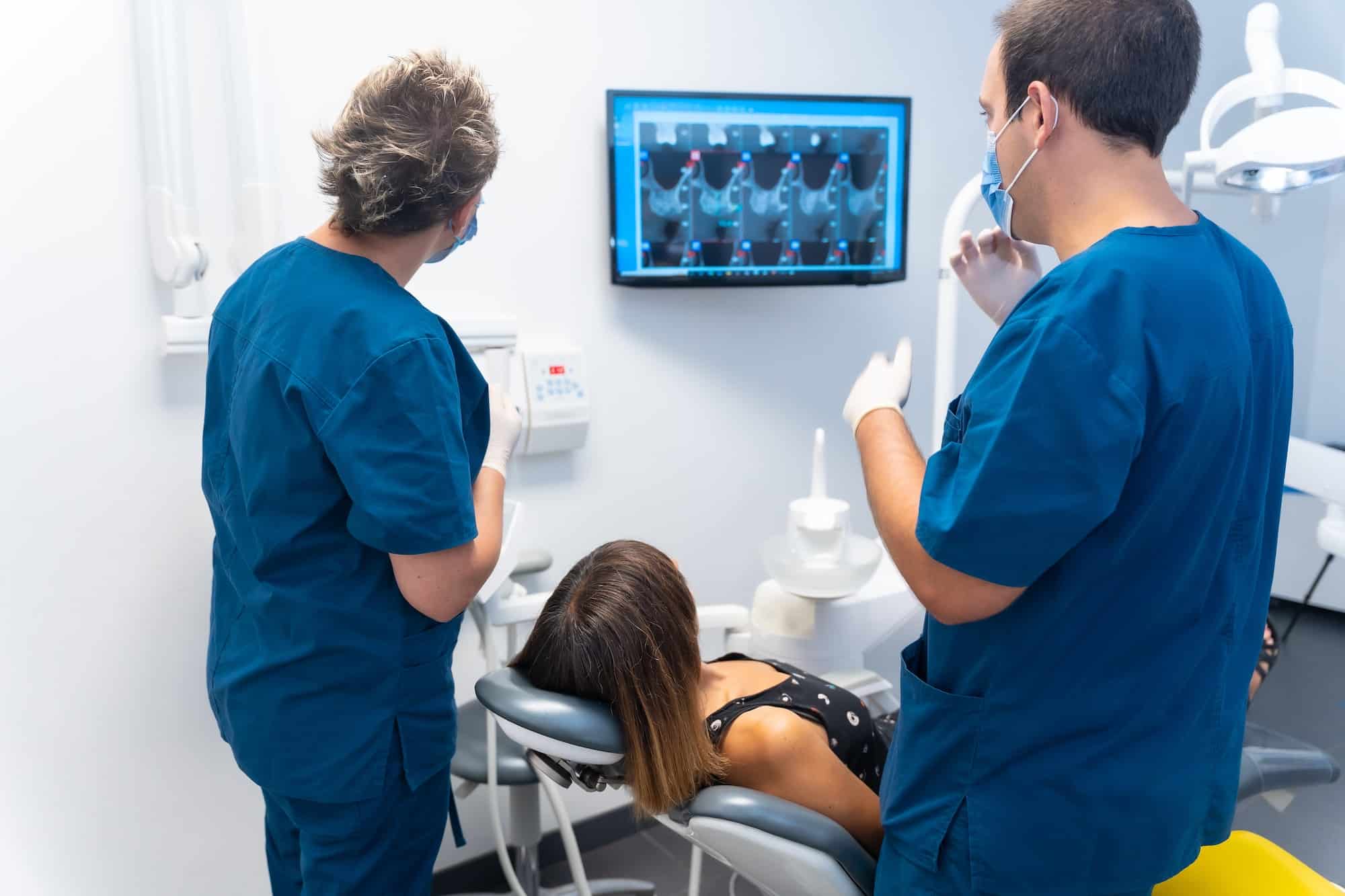 Dental clinic, doctors explaining to the patient saying how her teeth are in the revision
